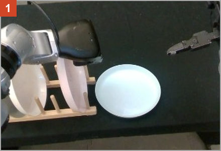 pi-0.5 reaches to pick a plate